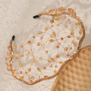 Detail of hand-woven gold wire bridal headband with crystals and beaded mesh