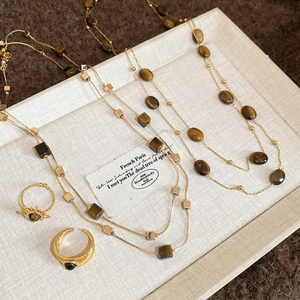 Vintage gold necklace set with tiger eye stone pendants and matching rings in retro style