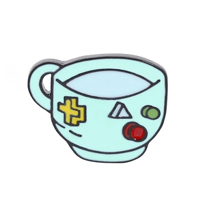 Detailed close-up of a blue enamel coffee cup brooch with colorful geometric patterns