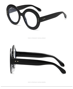 Detailed views of black oversized round frame glasses with elegant gold rivet accents