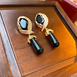 Vintage gold-plated drop earrings featuring large black faceted gems and crystal borders