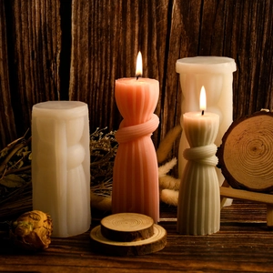 Detailed view of striped knot pillar candle silicone molds with finished wax samples