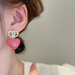 Elegant heart-shaped drop earrings with pink quilted patterns and crystal accents