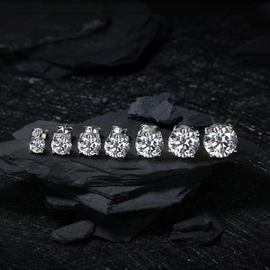 Detail view of seven S925 sterling silver stud earrings in various sizes on stone