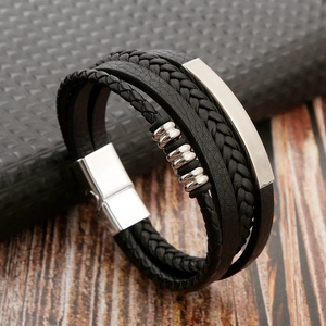 Macro shot of multi-layer black braided leather bracelet with stainless steel magnetic clasp