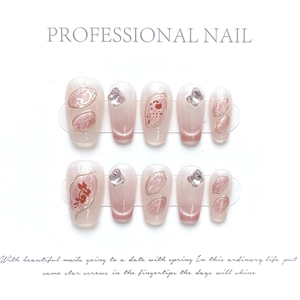 Pink cat eye press-on nails with 3D butterfly rhinestones and flower petal designs