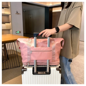 Pink large travel bag shown fixed on a white suitcase handle for convenient transport