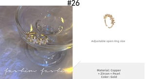 Detail of adjustable gold floral ring with zircon petals and pearl center for women