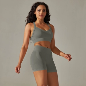 Detail of sage green seamless yoga set with cross straps sports bra and high waist shorts