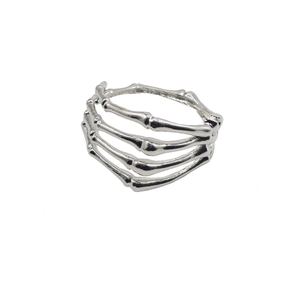 Detailed view of silver skull skeleton hand bracelet showing metallic bone structure