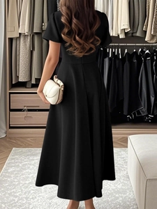 Elegant short sleeve black A-line evening dress for women in a boutique setting