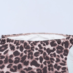 Macro shot of leopard print fabric detail showing high-quality stitching and white lining