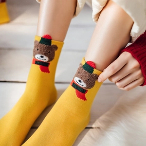 Yellow knit Christmas crew socks featuring a 3D cartoon bear with a holiday scarf