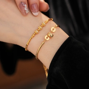 Close-up of 18K gold plated bamboo link bracelet set with zircon stones on wrist
