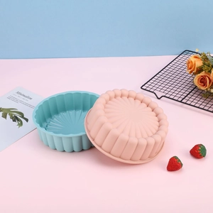 Sunflower shaped silicone cake molds in blue and pink on a minimalist background
