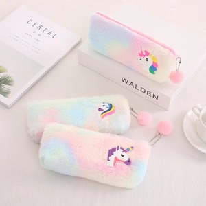 Rainbow plush unicorn pencil case with pom-pom keychain on a soft lifestyle background