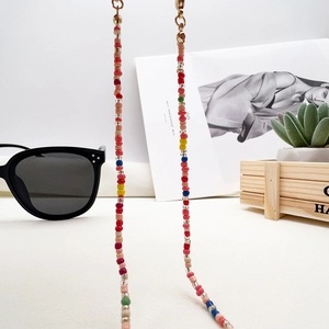 Rainbow glass seed bead glasses chain displayed with sunglasses and succulent plants
