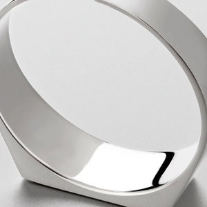 Detailed macro view of a polished stainless steel ring with sharp geometric facets