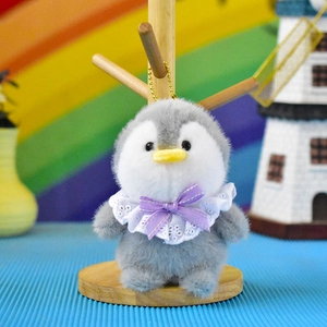 Adorable grey and white plush penguin bag charm with purple bow and lace collar detail