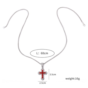 Detail shot of silver necklace with red rhinestone cross pendant including size dimensions