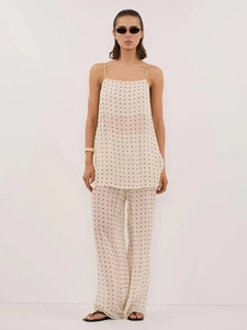 Detailed view of the polka dot camisole and high-waisted wide-leg trousers set