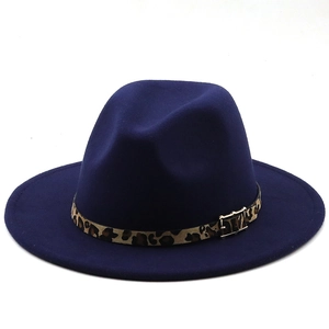 Detail of dark blue wool fedora with leopard print band and golden metal buckle