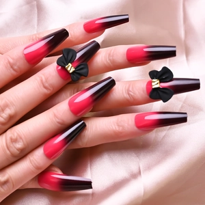 Long red and black gradient coffin fake nails with 3D black bow details on pink satin