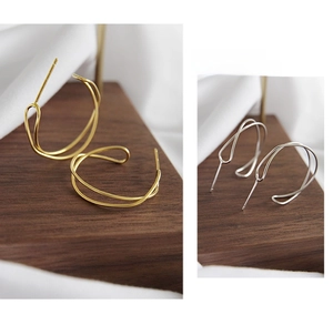 Macro view of S925 sterling silver earrings featuring a twisted wave pattern design