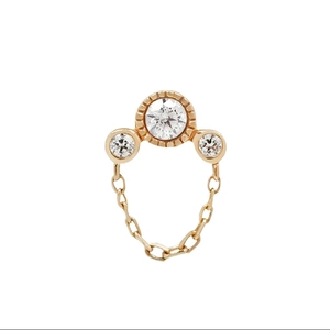 Macro shot of S925 silver gold-plated stud earring with three sparkling diamond tassels
