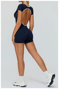 Macro detail of athletic romper featuring cutout back and contrast navy white binding