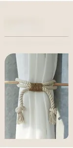 Detail of hand-woven cotton and jute rope curtain tieback with decorative tassels