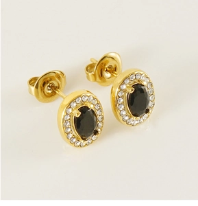 Detail of gold-plated stainless steel earrings with oval black gem and zircon halo
