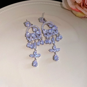 Macro view of vintage silver tassel earrings with clear cubic zirconia in a chandelier style