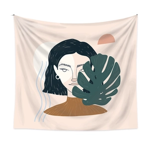 Detail of minimalist tapestry featuring female portrait and monstera leaf on fabric