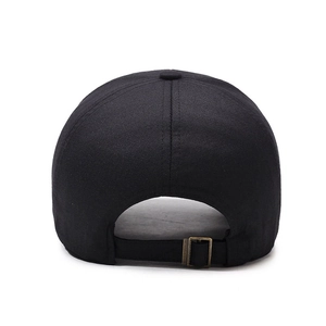 Rear view of black cotton baseball cap showing adjustable bronze metal buckle strap