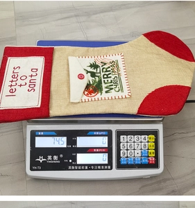 Close-up of rustic burlap Christmas stocking with Merry Christmas print and side pocket