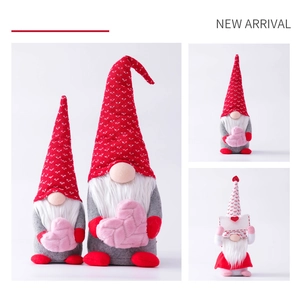 Detail of plush Valentine gnomes with red knit hats holding pink hearts and envelopes