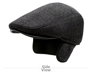 Detail of vintage grey plaid newsboy cap featuring ear flaps and leather trim