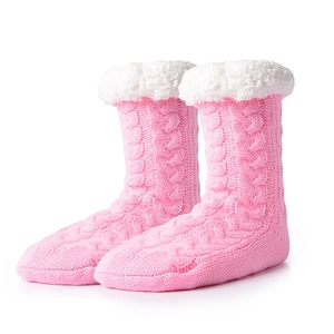 Detail of pink knitted thermal slipper socks with soft white faux fur trim and warm lining