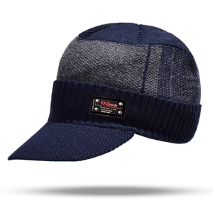 Detail of navy and grey knit beanie with leather fashion label and thick warm textures