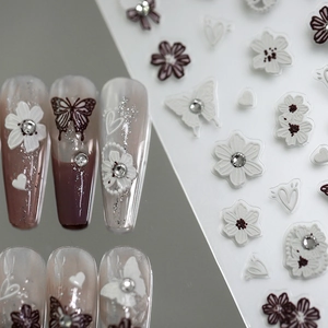 5D embossed nail art stickers featuring white flowers, purple butterflies and rhinestones
