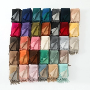 Detailed grid view of various colorful soft scarves with fringed edges and contrast borders