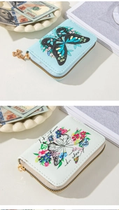 Detail of mini butterfly floral embossed wallets in light blue and cream faux leather