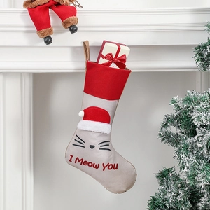 Creative beige and red Christmas stocking with cat face and I Meow You text hanging on a mantel