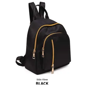 Side view of black mini nylon backpack showing waterproof layers and gold metal zippers