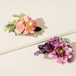 Detail of handmade silk flower hair combs in pink and purple colors with metal pins