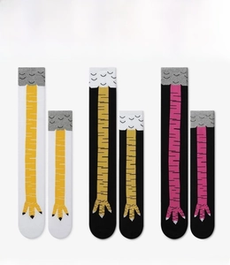 Close-up showing funny chicken feet pattern on knee-high socks in three colors