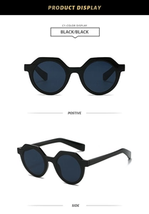 Close-up of retro black polygon sunglasses with glossy thick frames and dark lenses