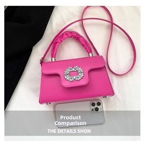 Detail showing fuchsia crossbody bag with sparkling crystal buckle and ruched handle