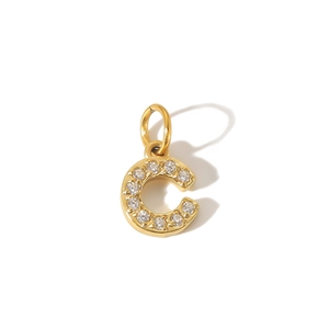 Macro shot of 18K gold plated letter C pendant inlaid with brilliant cubic zirconia